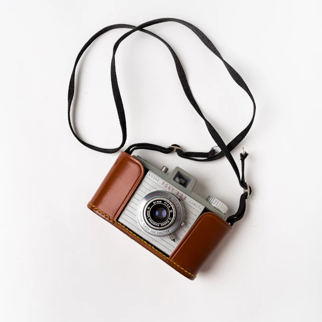 Vintage 35mm film camera photographed in the front seat of a car