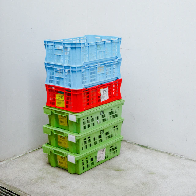 Stacked storage bins full of unlisted reseller inventory